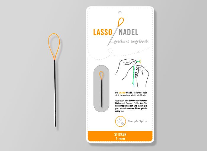 Ansicht auf die Verpackung und links daneben die Nadel mit Schlaufe.
