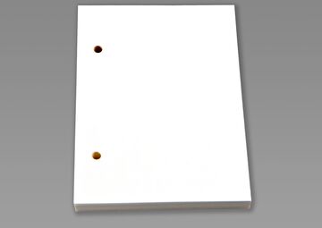 Ansicht auf das weiße Braille-Papier mit Lochung.
