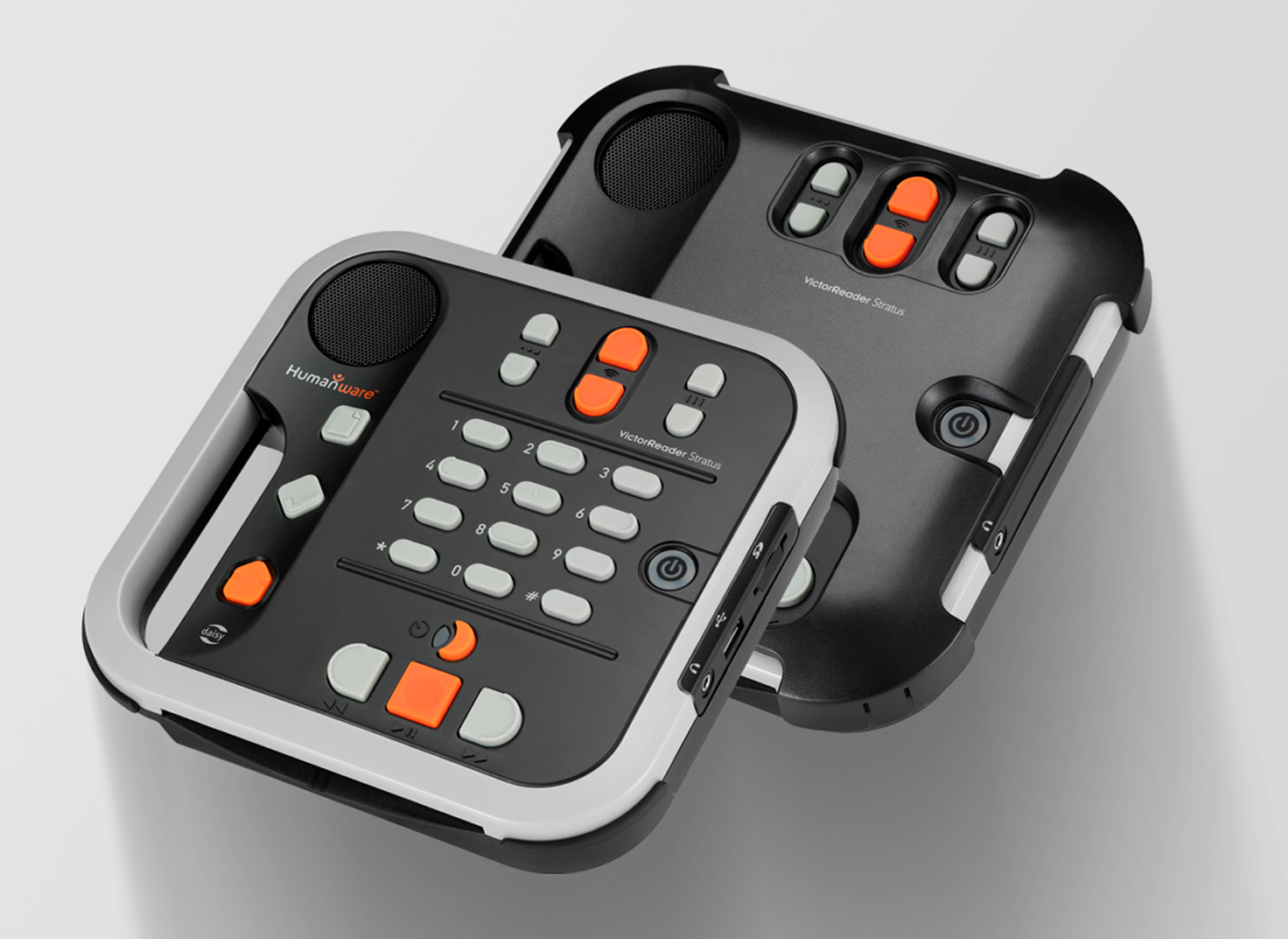 Ansicht auf das Gerät in Schwarz mit grauen und orangenen Tasten.